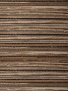Close-up texture of stacked cardboard for recycling or crafting. Ideal for background use.